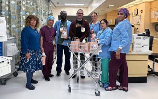 Doctor handing out swag bags for nurse staff.