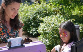 Child getting facepaint applied.
